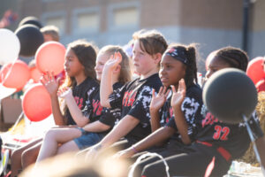 Little League softball players watching the parade