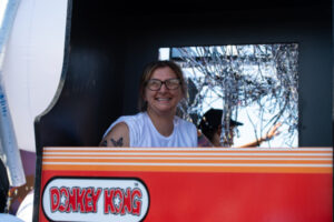 A passenger on a parade float waving to the crowd